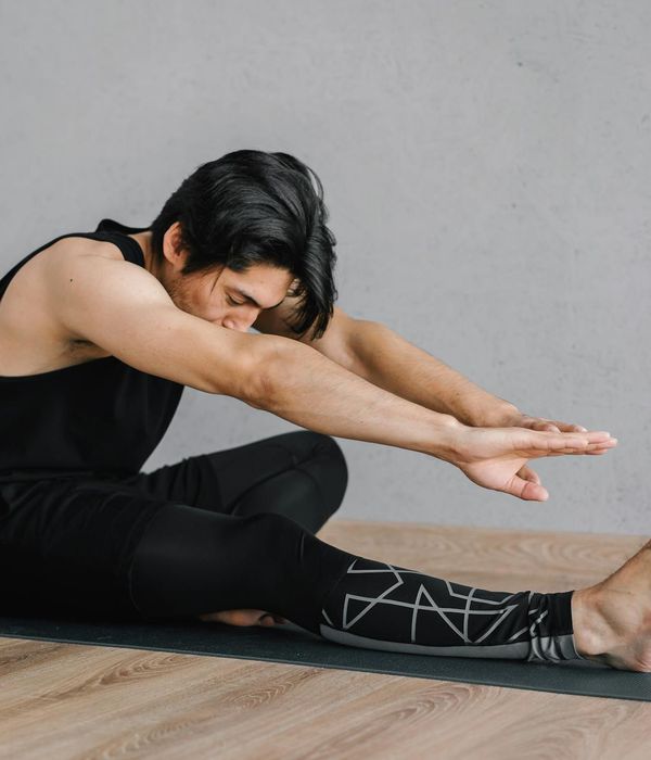 Man in athletic wear planning his workout routine on a tablet.